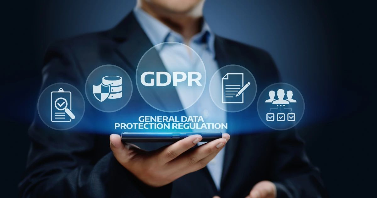 Suited person holding a smartphone with glowing GDPR icons and General Data Protection Regulation text overlaid