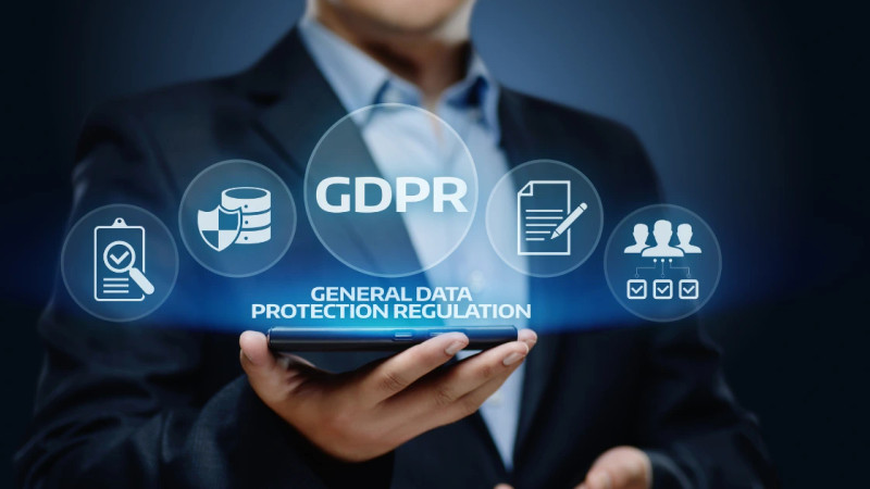 Suited person holding a smartphone with glowing GDPR icons and General Data Protection Regulation text overlaid