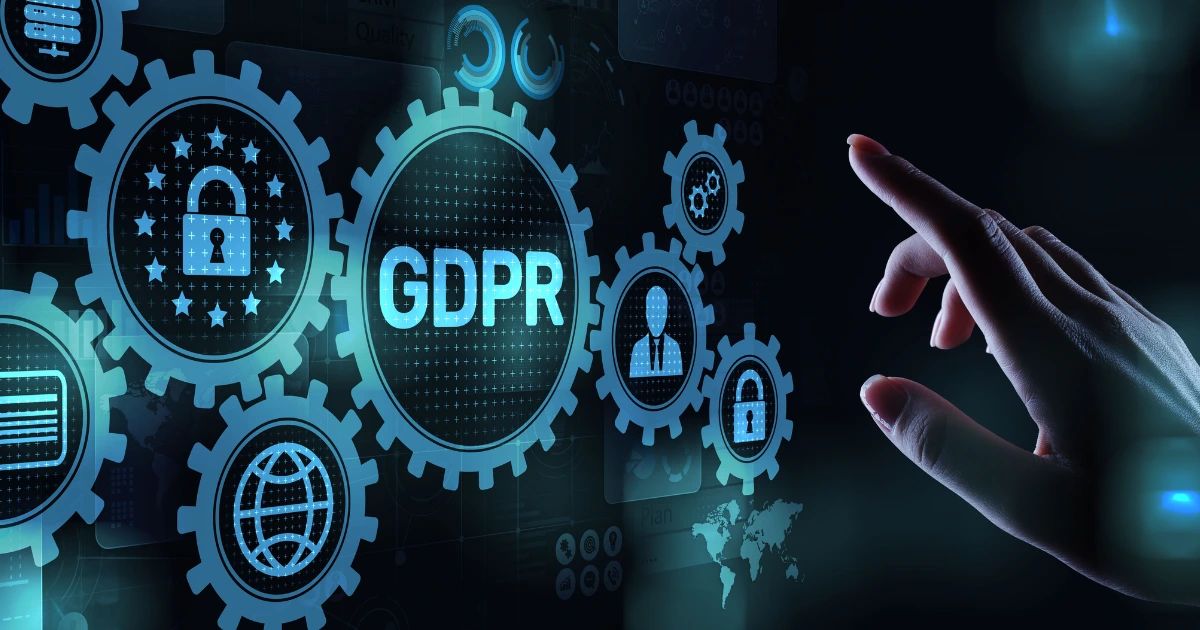 Hand pointing at glowing GDPR digital interface with gear icons, padlocks and globe symbols on dark background