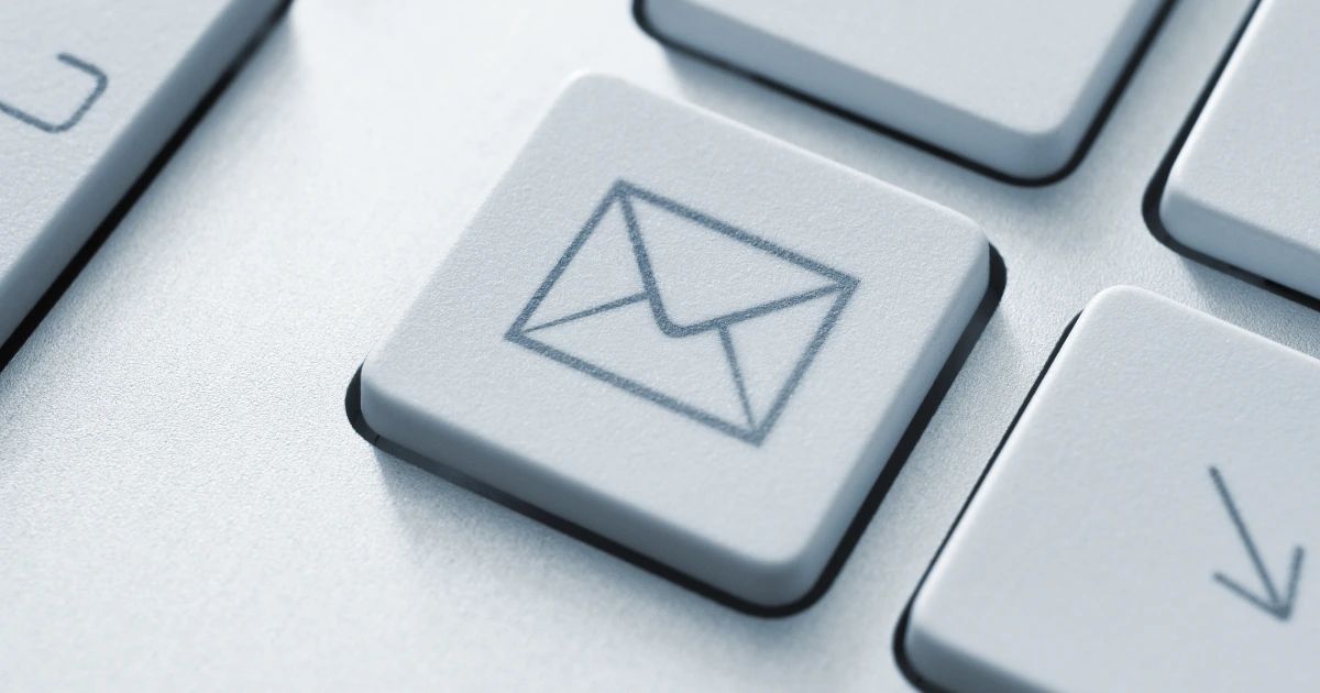 Close-up of a keyboard key with an envelope email icon engraved on its surface