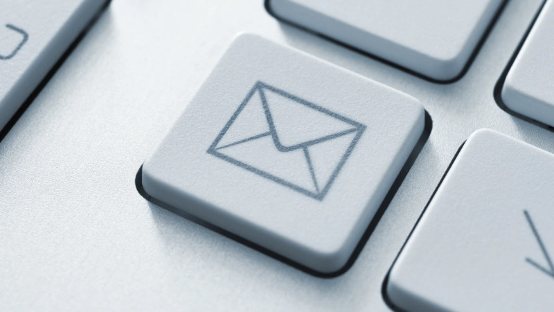 Close-up of a keyboard key with an envelope email icon engraved on its surface